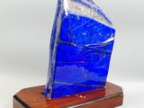 sculpture of a blue stone on a wooden base on a white background
