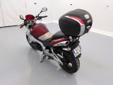 a red and black motorcycle parked in a white room