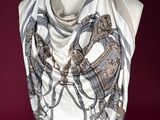 a woman wearing a scarf with a horse on it
