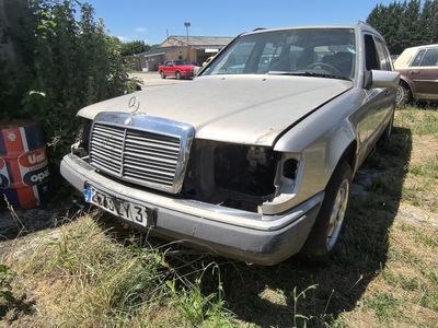 a silver car that is sitting in the grass