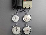 five stopwatchs and a wallet on the table