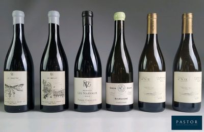 several bottles of wine are lined up on a table