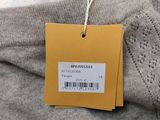 an image of a label on a sweater hanging on a hanger