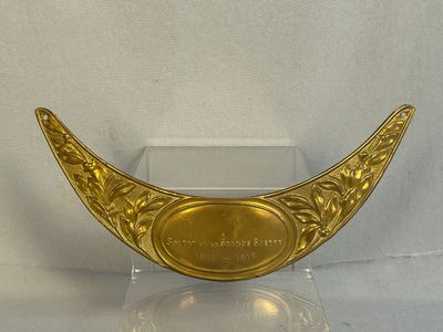 a gold plate with a plaque on it on a stand