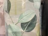 two rolls of toilet paper with green leaves on them