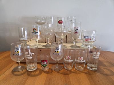 a lot of wine glasses sitting on a wooden table