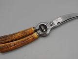 a close up of a knife with a wooden handle