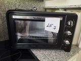 a toaster oven sitting on a counter with a note taped to it
