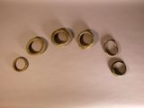 five rings that are sitting on a white surface