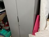 a closet with a sink and a bed in it