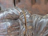 a close up of a statue of a person laying on the ground