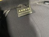 the back of a black jacket with a yellow teddy bear on it