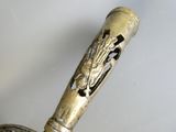 a close up of a metal object with a horse on it