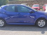a blue car that is parked in a parking lot