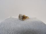 a close up of a gold and silver ring on a white surface