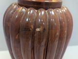 a brown vase that is sitting on a table
