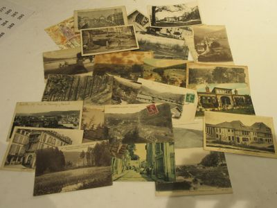 a pile of old postcards sitting on top of a table