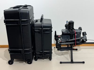 two black suitcases sitting next to each other on the floor