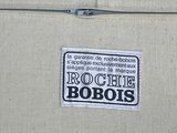 a sticker on the back of a suitcase that says roche robois