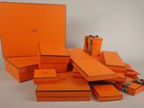 orange boxes are stacked on top of each other on a white surface