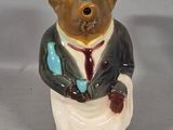 a figurine of a bear dressed in a suit and tie