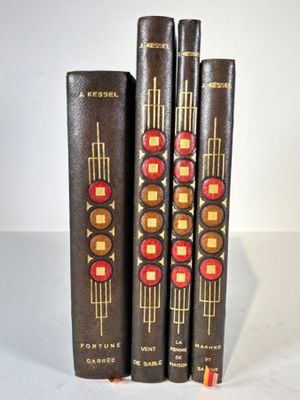 three books are stacked on top of each other on a white surface