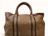 an image of a brown leather bag on a white background