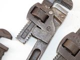 two adjustable wrenes on the table next to each other