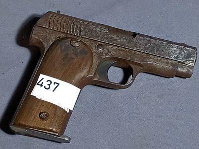 a wooden gun with a tag on it on a table
