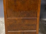 an old wooden chest of drawers with granite top in a room