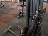 a gym with a row of machines in the middle of the room