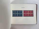 an open book with two stamps on it sitting on a table