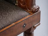 a wooden chair with a brown upholstered seat and a brown upholstered seat