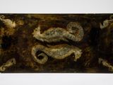 an image of a metal plaque with two seahorses on it