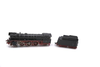two toy trains sitting side by side on a white surface