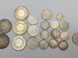 several different types of coins are arranged on a white surface