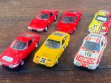 several toy cars are lined up in a row on a wooden table