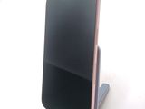a phone that is sitting on a stand on a table