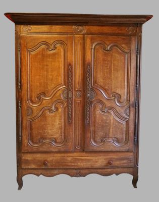 an old wooden armoire with carvings on the doors and drawers