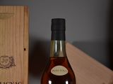 a bottle of wine sitting next to a wooden box
