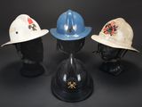 three hats are sitting on top of each other on a black surface