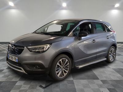 a grey opelge is parked on a checkered floor