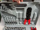 a person holding a wrenet in a tool case