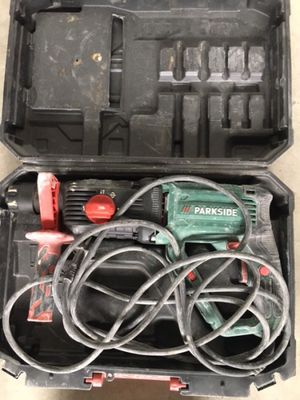 a box with a corded drill and a corded hammer in it