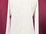 a white shirt on a mannequin stand against a red background