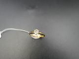 a close up of a gold ring with a diamond on it