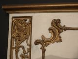 a mirror that has a gold frame on it