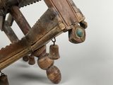 a wooden sculpture of a mechanical device on a white surface