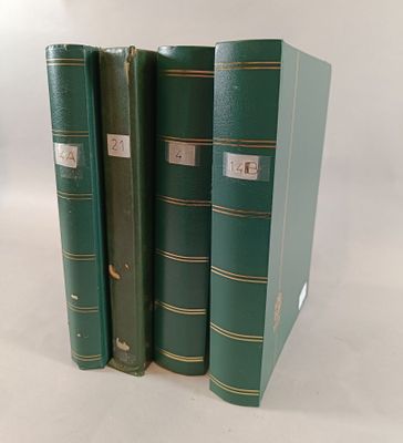 trois livres verts superposés sur une surface blanche