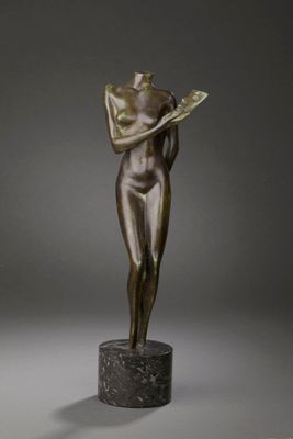 a bronze statue of a woman reading a book on a marble pedestal